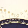 Close-up of gold screen-printed Moon phase symbols for February and March on the 2027 astronomical calendar.
